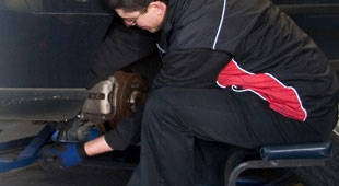 Repairing brakes on a car.